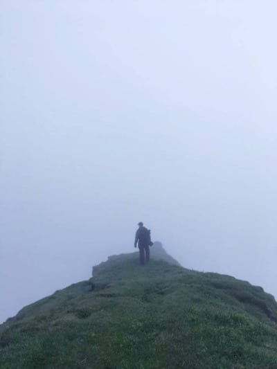 nathan stands in fog on faroe islands