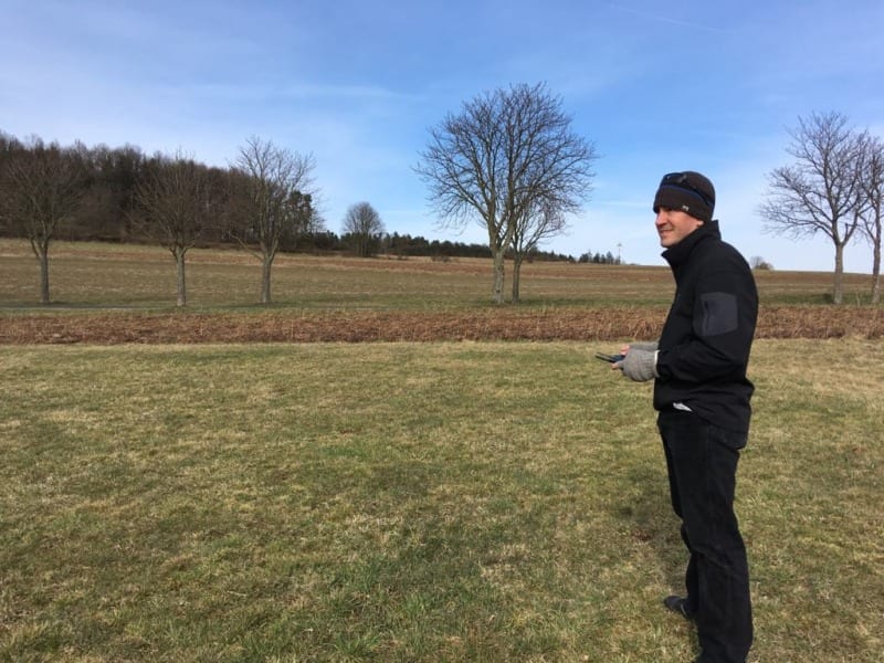 nathan flies a drone in a field